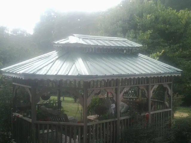 Two tier green metal roof on a garden gazebo in Tumtum
